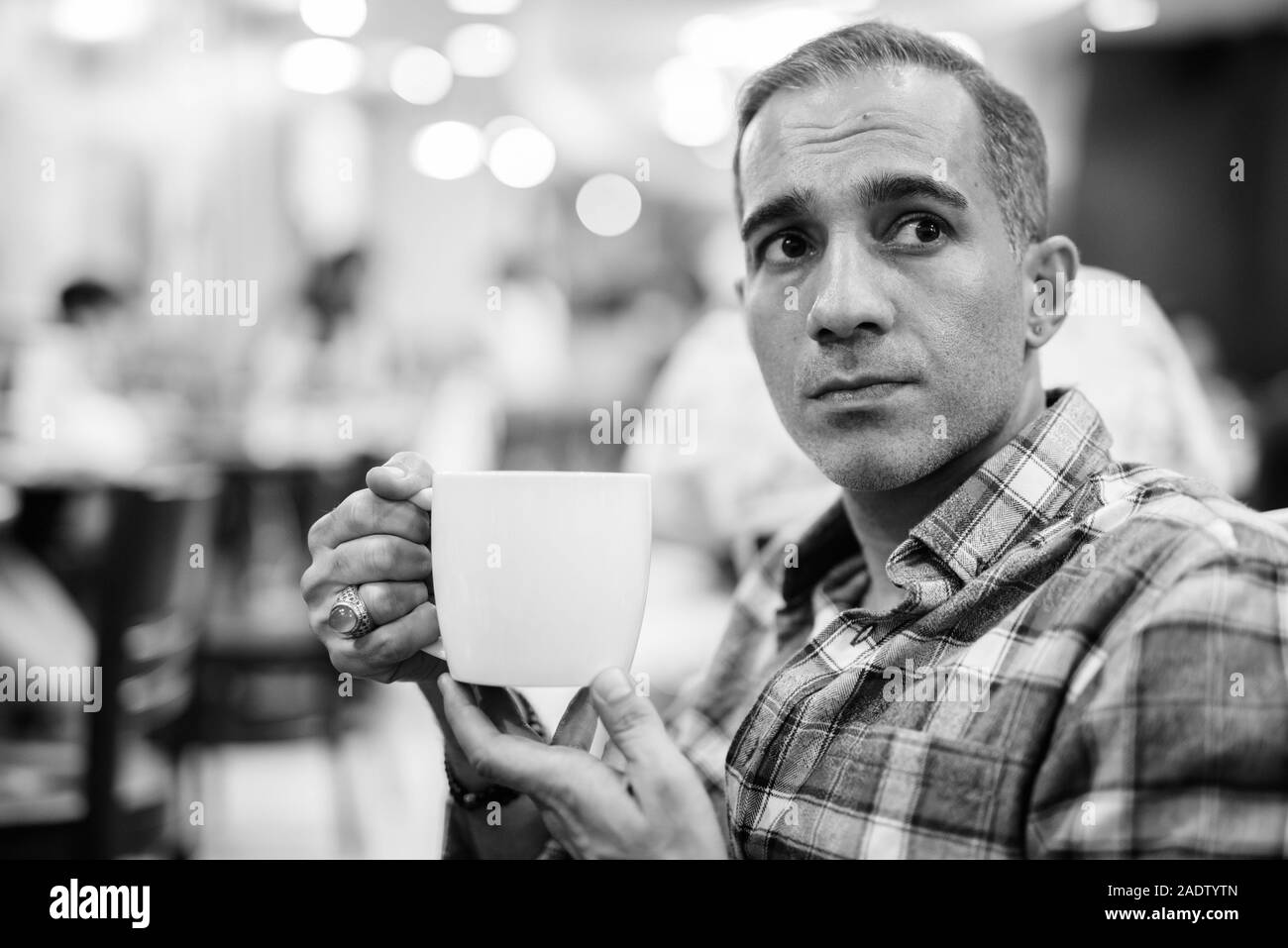 Maturo uomo persiano rilassante all'interno del coffee shop Foto Stock