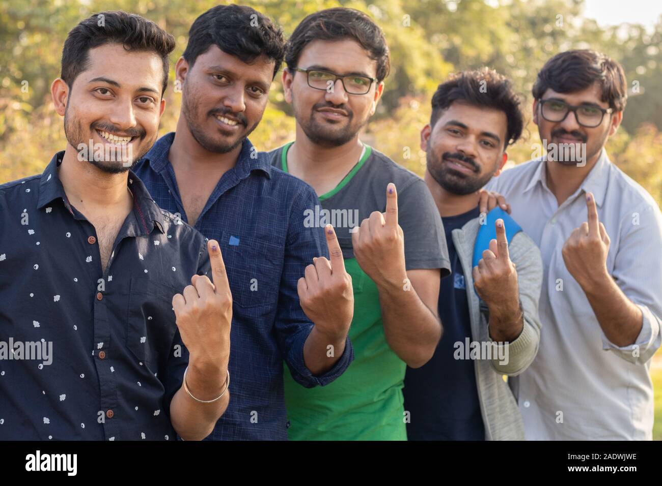 Gruppo di giovani gli elettori indiani che mostra le dita dopo la colata si voti. Foto Stock