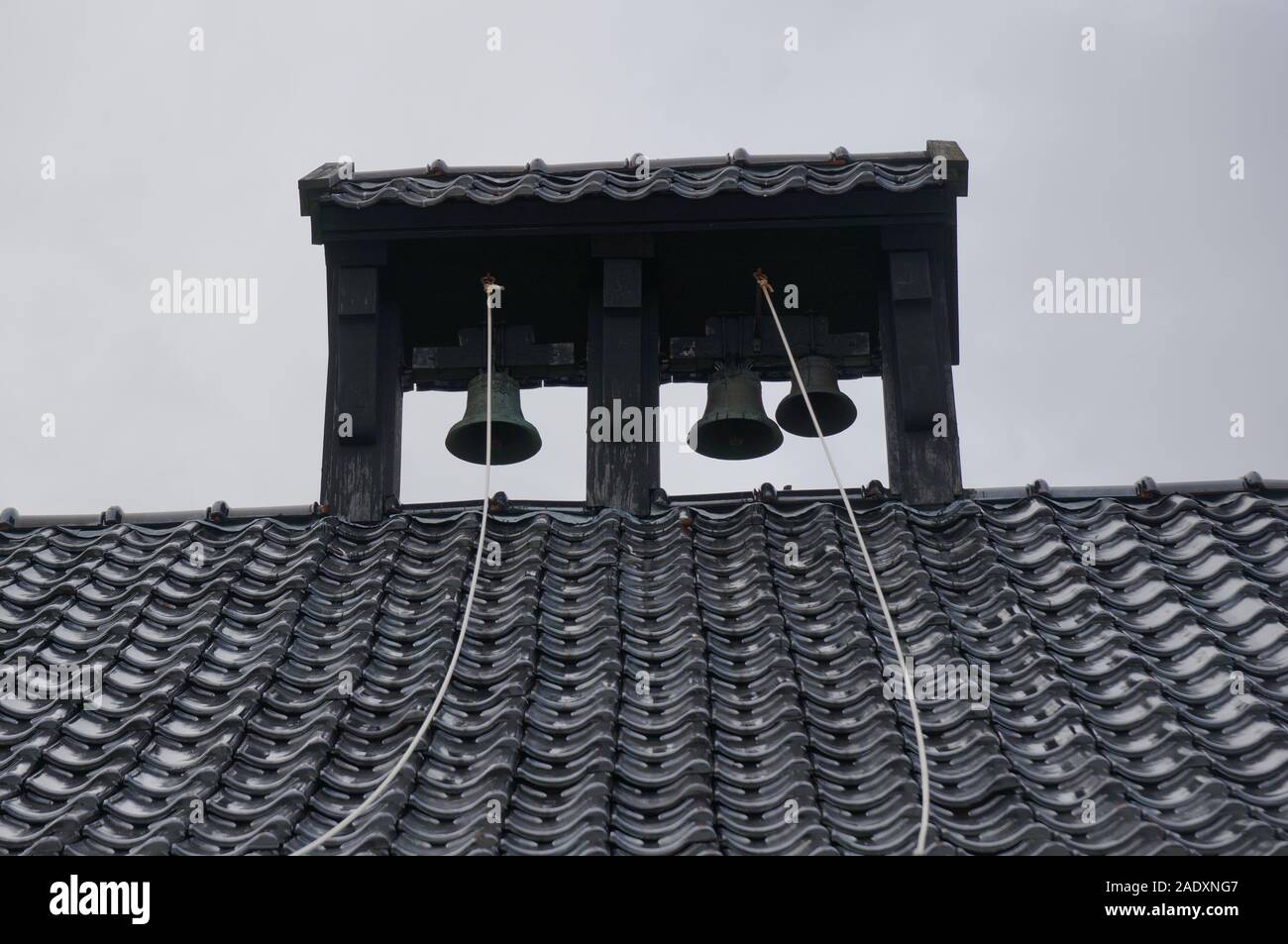 Nero tetto tegola con campane sull isola Videy, Islanda Foto Stock