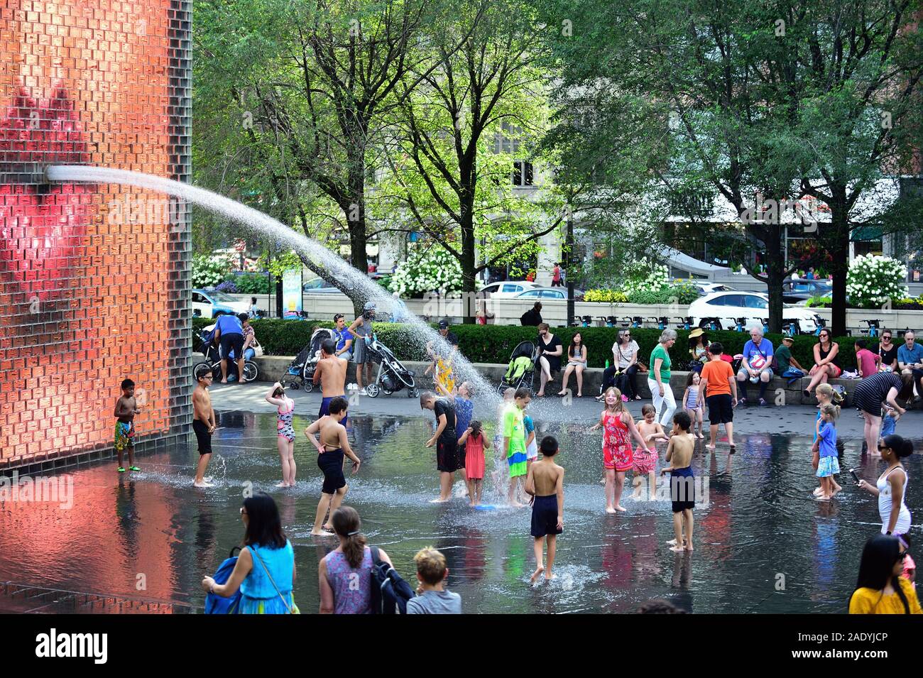 Chicago, Illinois, Stati Uniti d'America. I bambini giocano a rinfrescarsi al Crown Fontana in Chicago's Millennium Park in una calda giornata estiva. Foto Stock