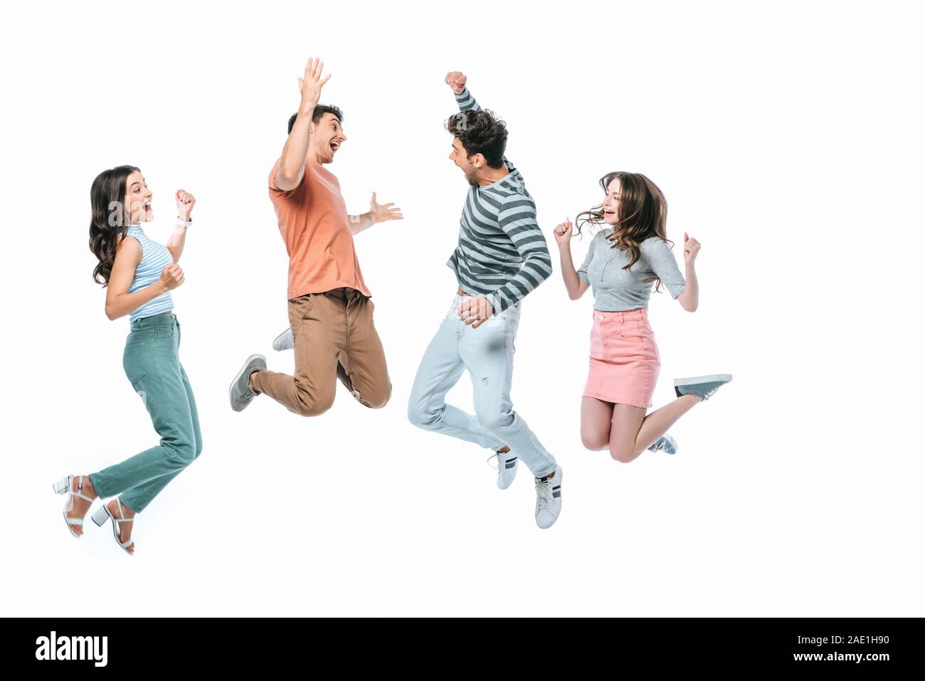 Emozionato amici jumping insieme, isolato su bianco Foto Stock