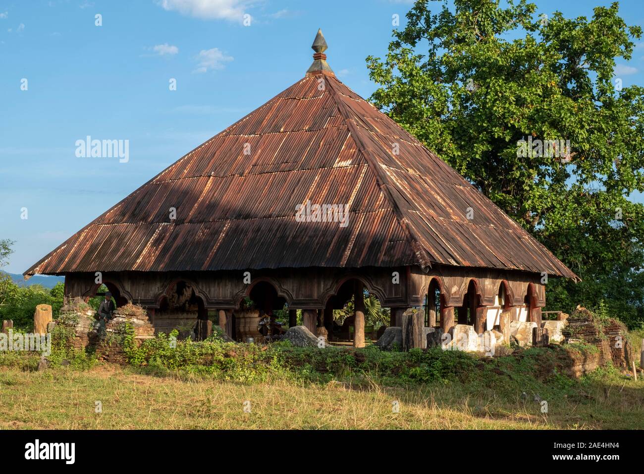 Un profilo arcuato sala cerimoniale con tetto dello stagno di un monastero buddista per condurre i rituali religiosi in un villaggio nelle zone rurali del nord-ovest del Myanmar (Birmania) Foto Stock