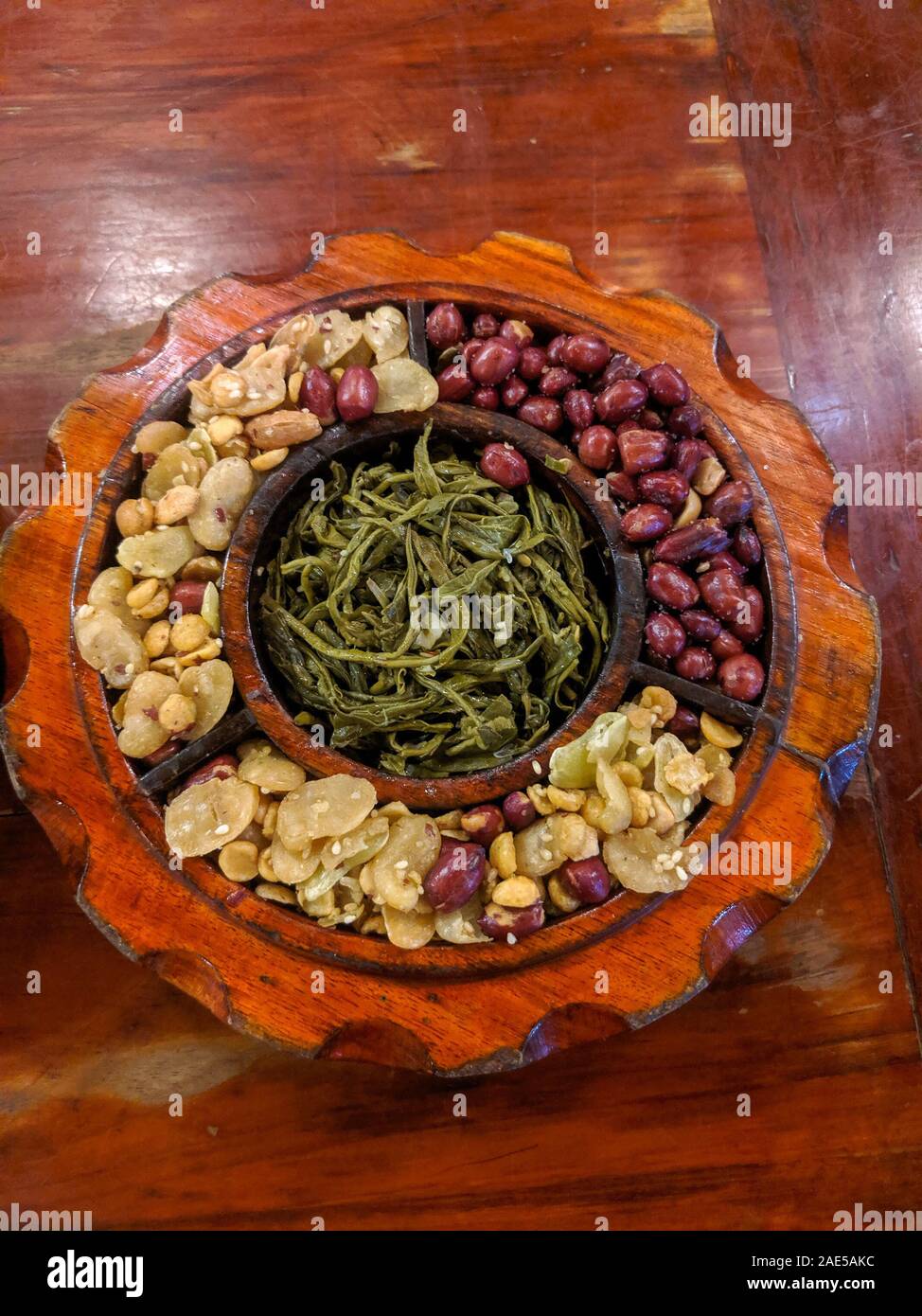 Stile birmano tradizionale tè sottaceto insalata in foglie, noto come lahpet thoke, costituito da foglie di tè e di arachidi. Foto Stock