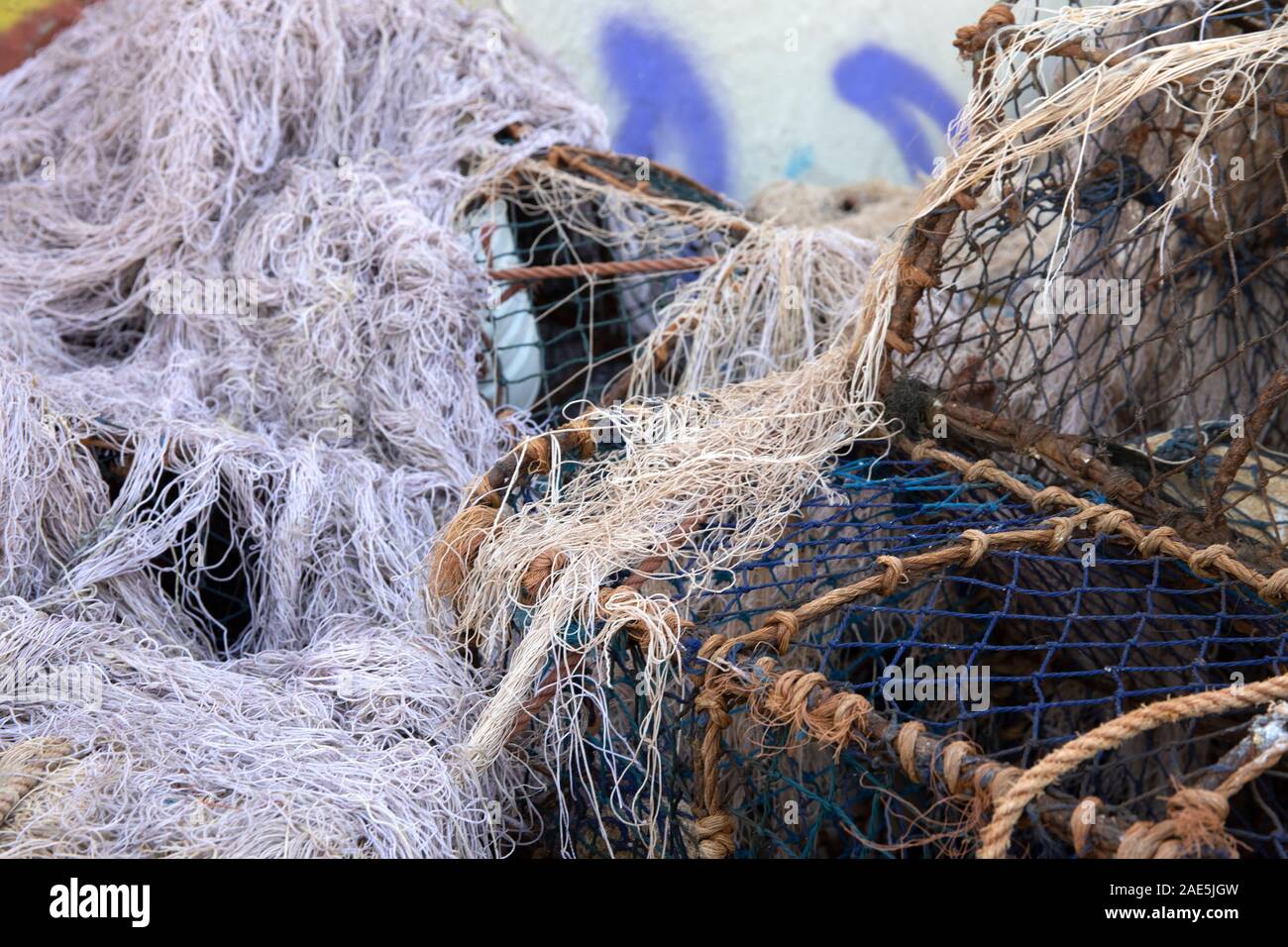 L'aggrovigliato reti da pesca a sedersi su un molo a Essaouira, Marocco Foto Stock