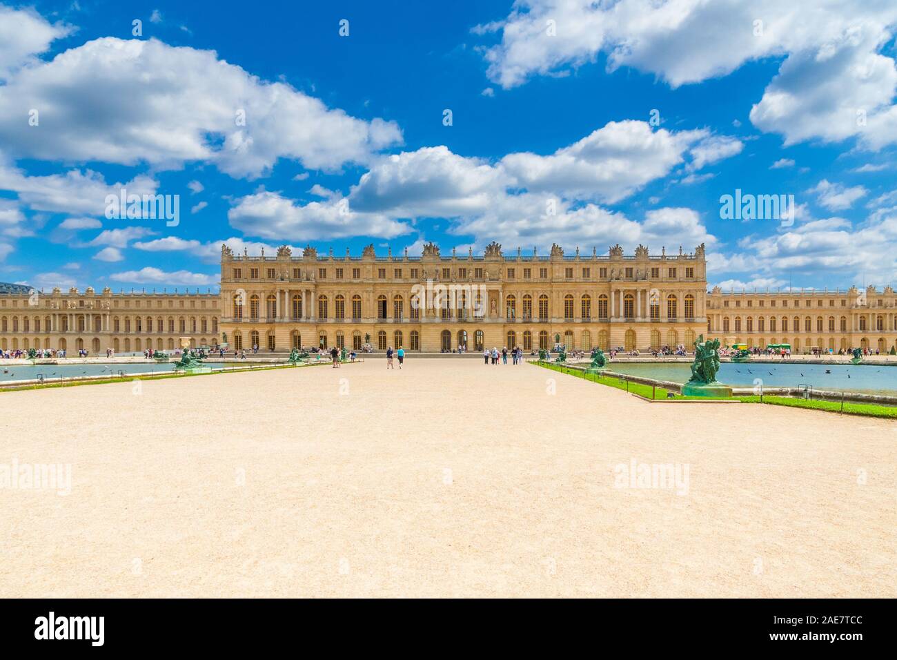 Bella vista panoramica della facciata ovest del palazzo di Versailles dal Parterre d'acqua con due piscine di forma rettangolare e un sentiero di ghiaia nel centro di ... Foto Stock