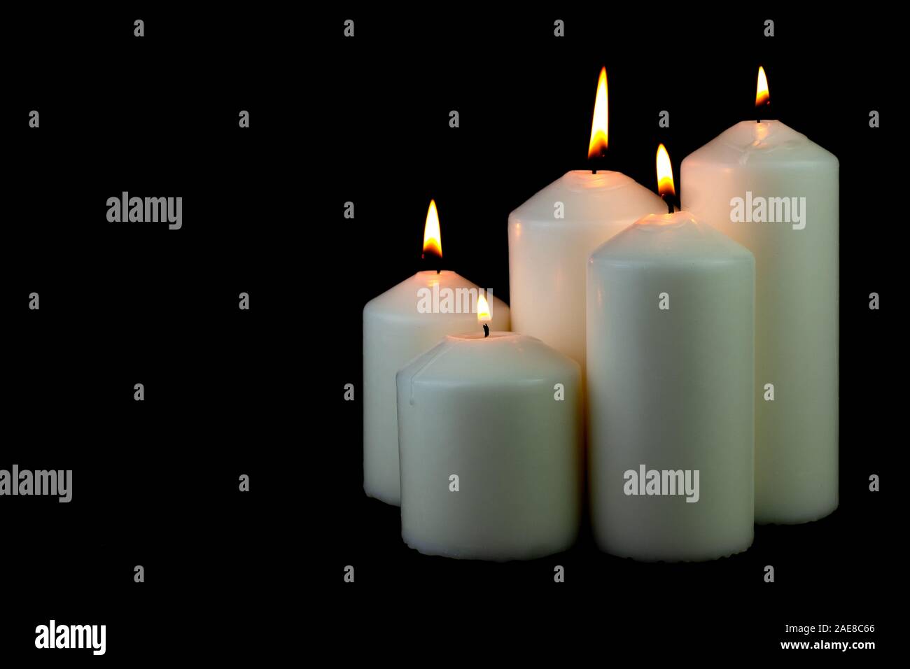 5 luce di candela di fiamma che brucia ardentemente su sfondo nero Foto Stock