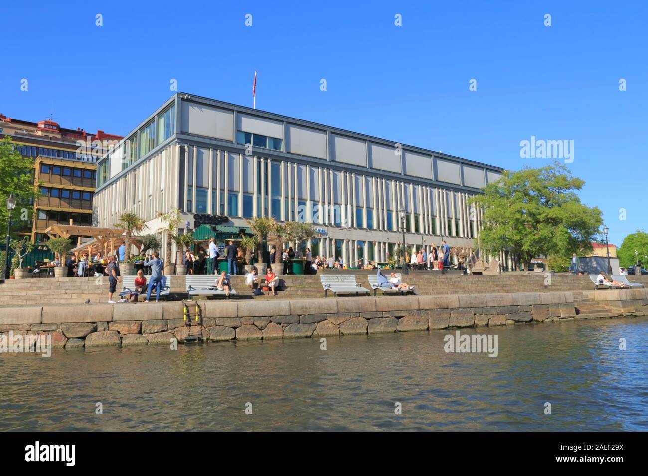 Persone potrete crogiolarvi al sole accanto a un canale esterno Boulebar Rosenlund a Gothenburg, Svezia, durante l'estate. Foto Stock