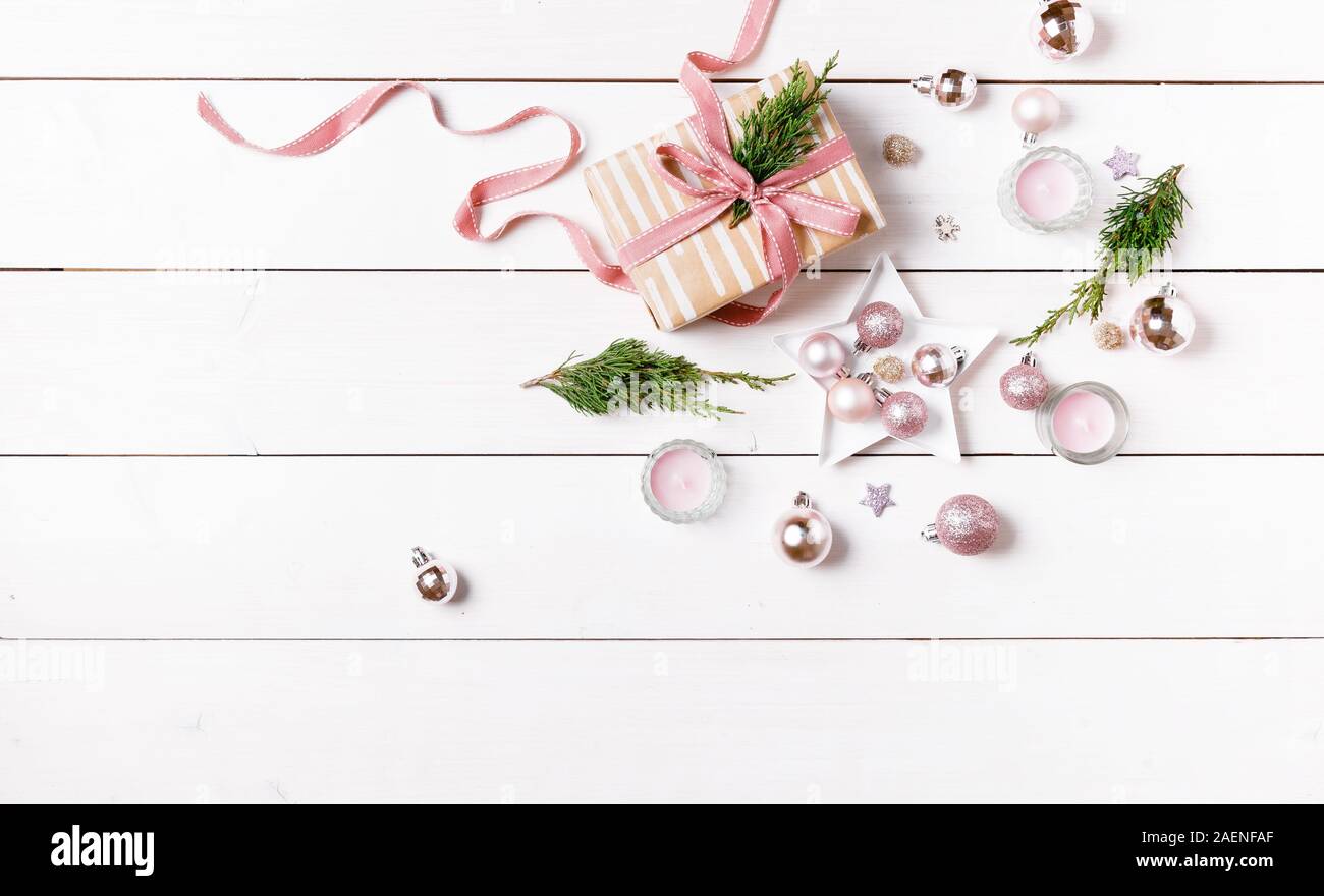 Preparazione regali di natale su una bianca tavolo in legno con decorazioni rosa Foto Stock