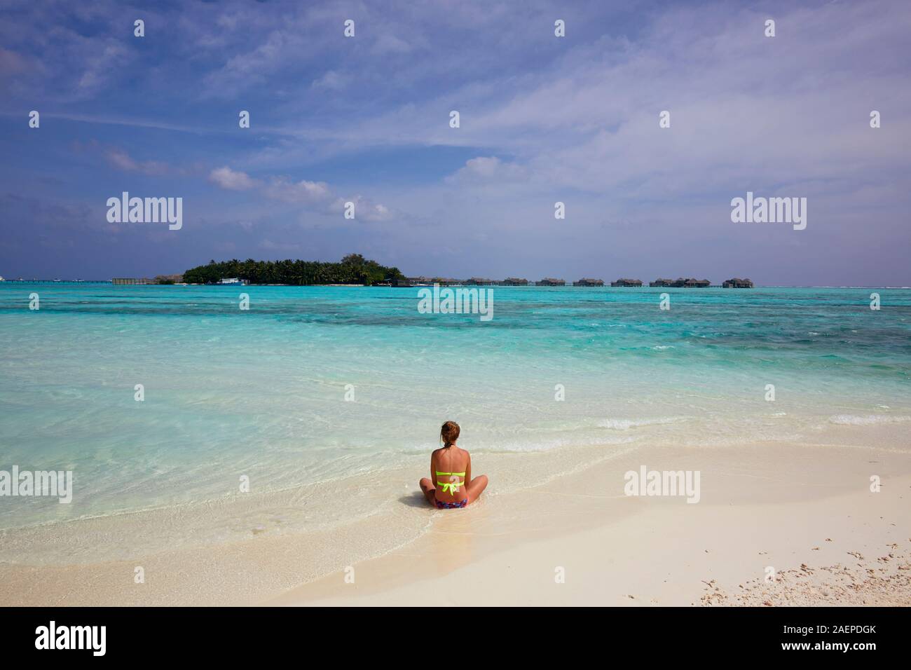 Donna relax sulla spiaggia di Paradise Island (Lankanfinolhu), Maldive Foto Stock