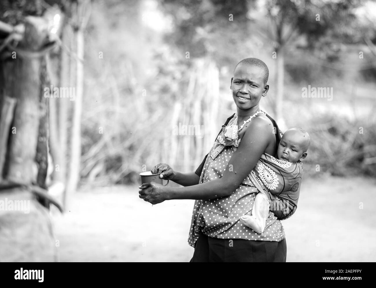 Stesso, Tanzania, 4 Giugno 2019: Maasai donna con il suo bambino sulla schiena Foto Stock