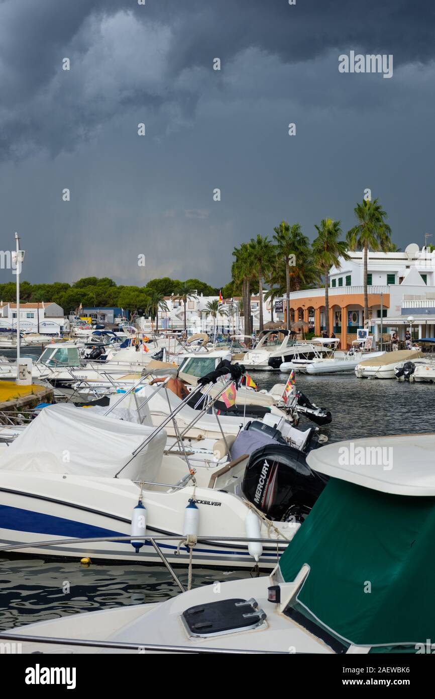 Drammatica nuvole temporalesche avvicinando Cala en Bosch marina, Menorca, Spagna Foto Stock