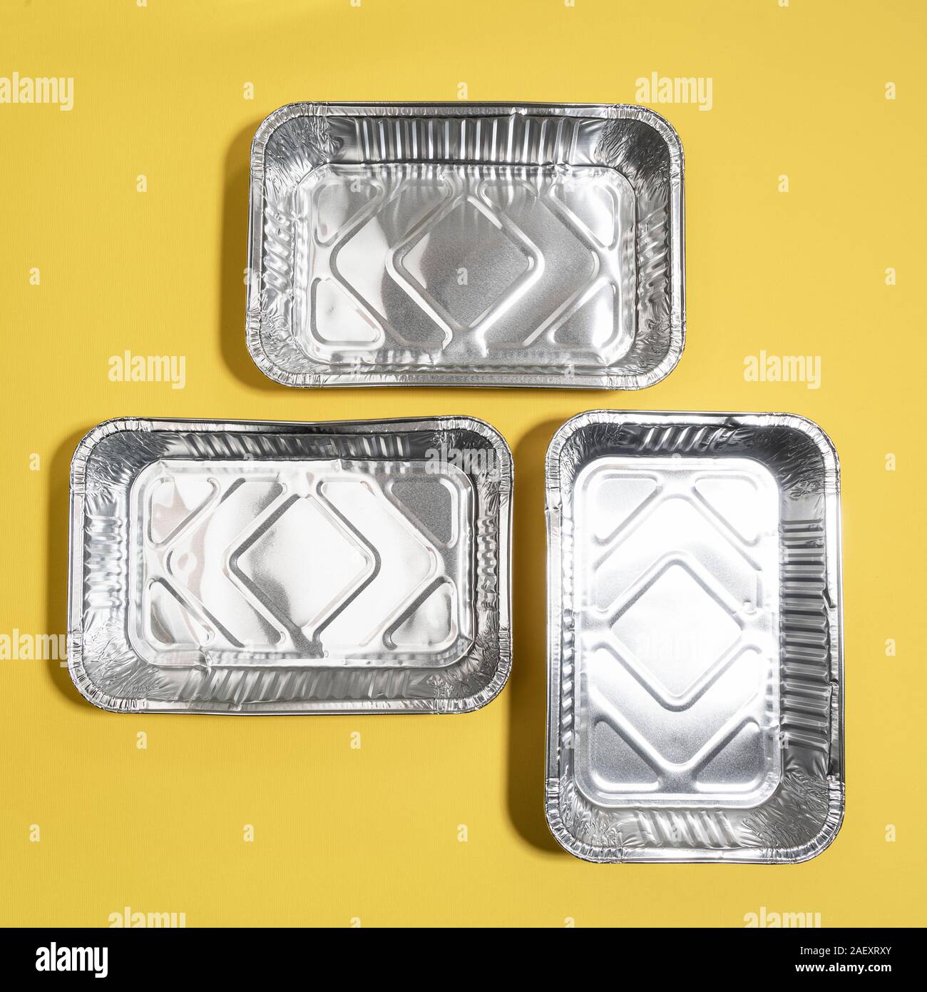 Vaschette di alluminio per uso in cucina su una superficie colorata Foto Stock