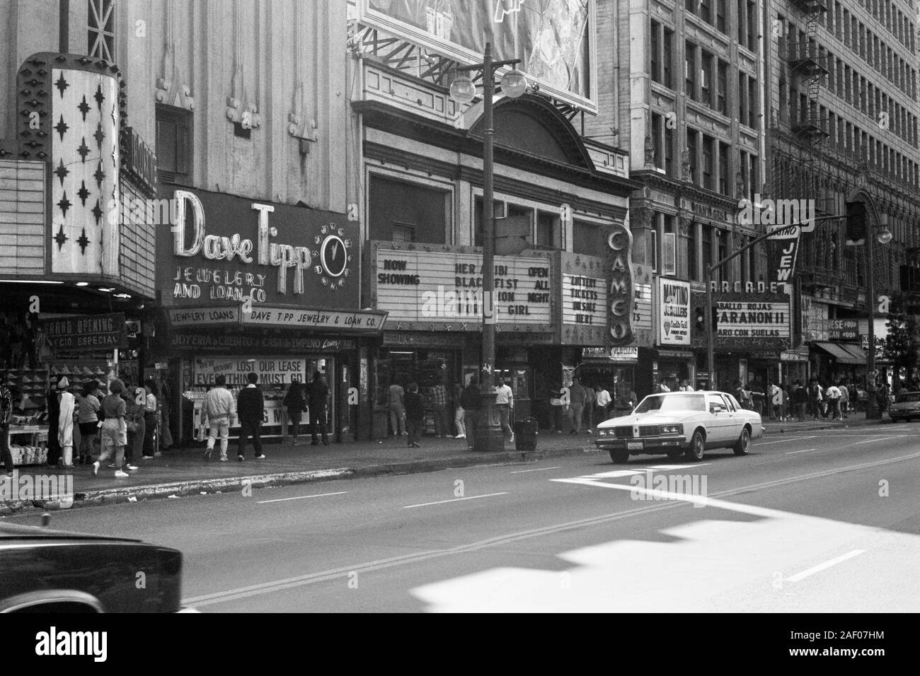 Los Angeles, California, Stati Uniti d'America - Dicembre 1989: Vintage in bianco e nero vista editoriale di teatri e negozi su Broadway vicino alla quinta strada. Foto Stock