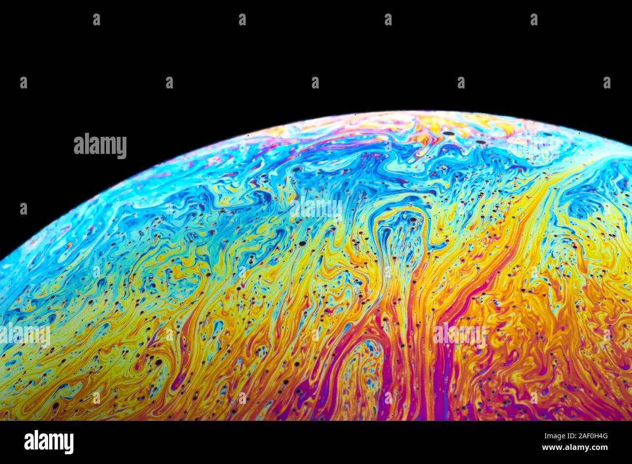 Ripresa macro di una bolla di sapone la simulazione di un pianeta Foto Stock