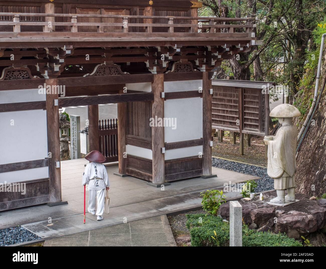 .Henro pellegrino e statua di Kobai Daishi, presso la porta del gateway house, tempio Butsumokuji 42, Shikoku 88 tempio pellegrinaggio, Ehime Giappone Foto Stock
