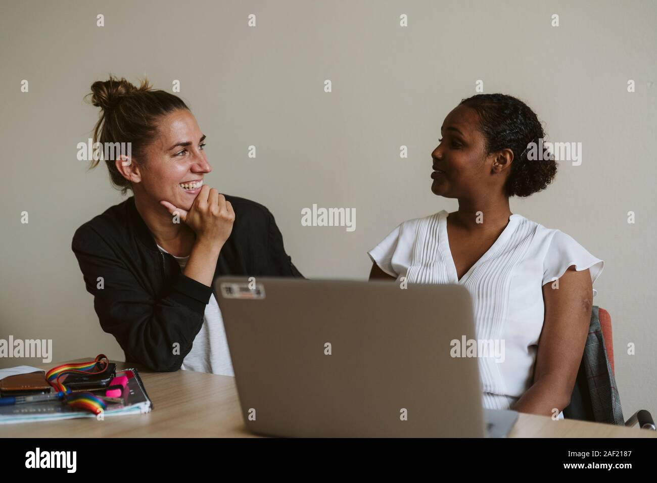 Donna sorridente parlando in ufficio Foto Stock