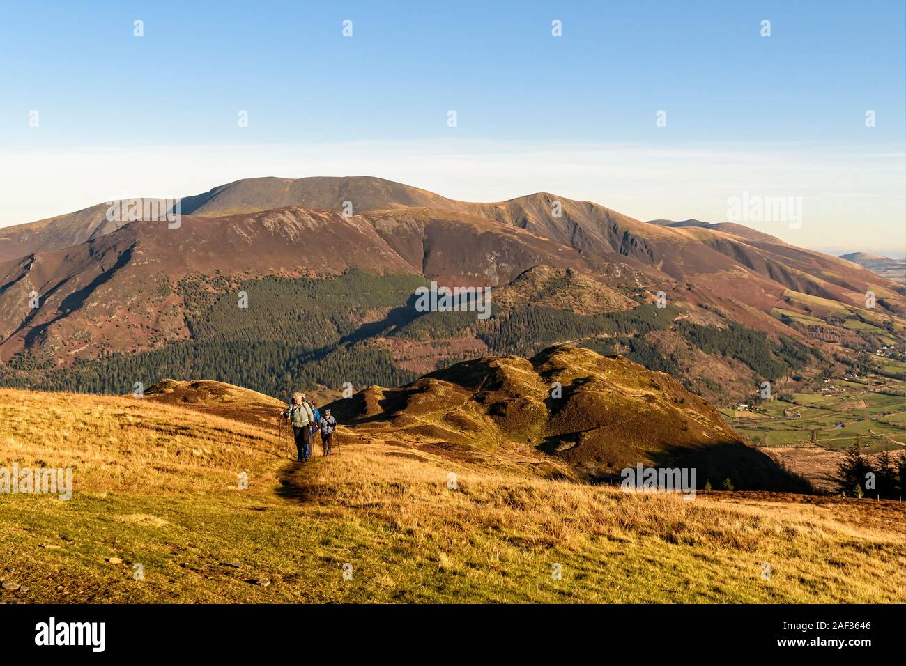 Un gruppo di escursionisti cadde in salita verso il Signore con sedile Barf e il Skiddaw fells dietro Foto Stock