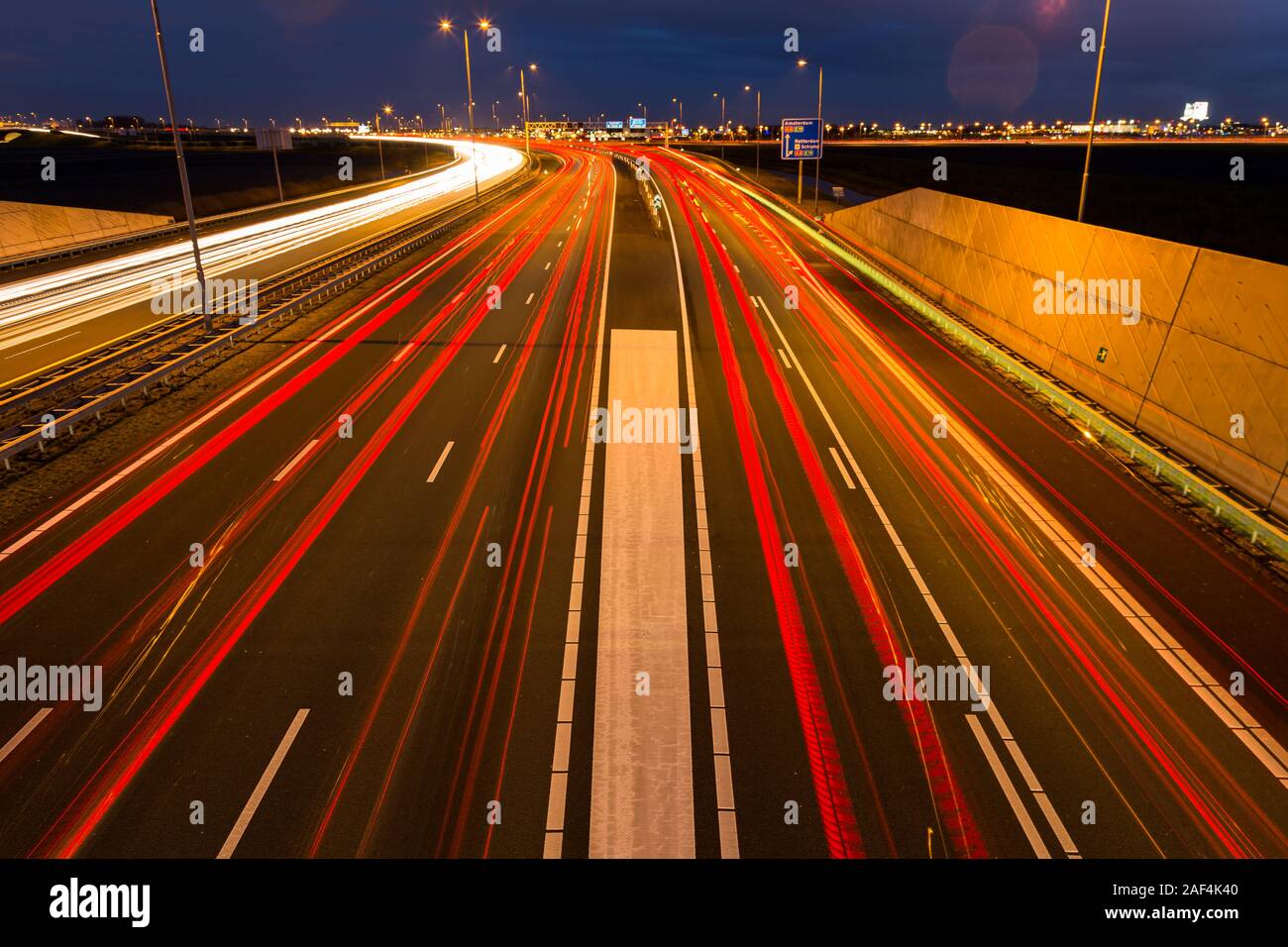 Occupato ora di punta il traffico lascia sentieri di luce sulla autostrada A9 nei pressi di Amsterdam, Schiphol di Haarlem. Foto Stock