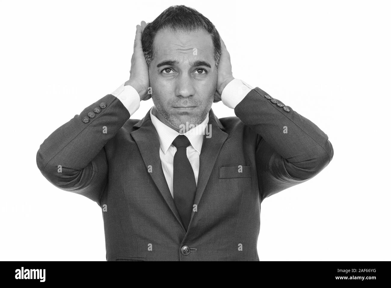 Coppia bello imprenditore persiano che copre le sue orecchie Foto Stock