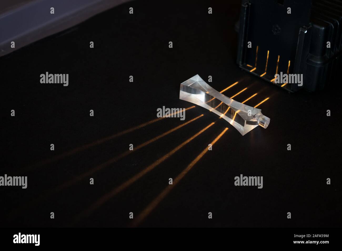 I fasci di luce passano attraverso una lente negativa, che mostra un modello di divergenti. Esperimento di fisica. Foto Stock