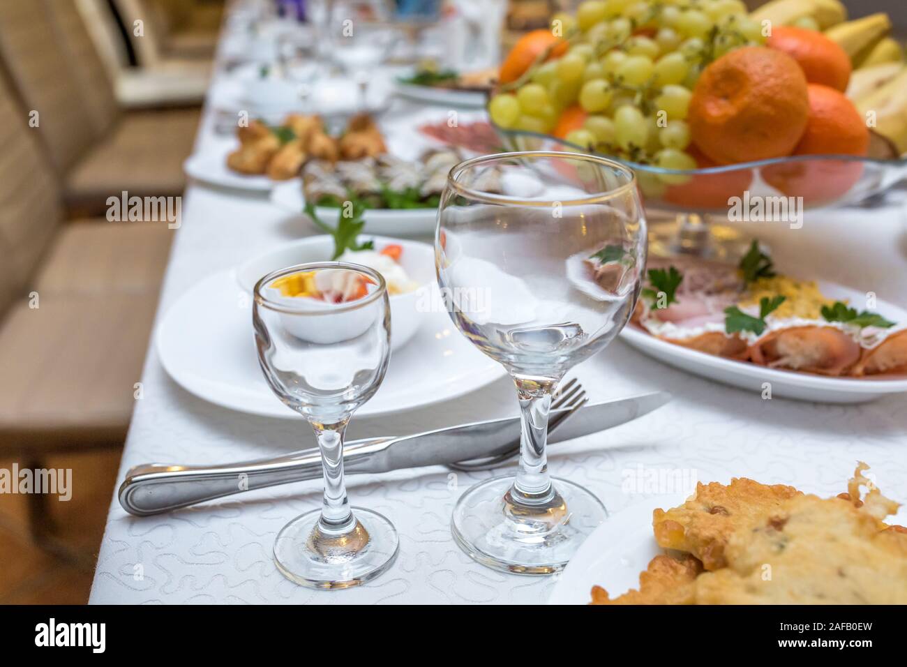 Tavola da banchetto servito con strumenti e decorate con vuoto bicchieri di vino Foto Stock