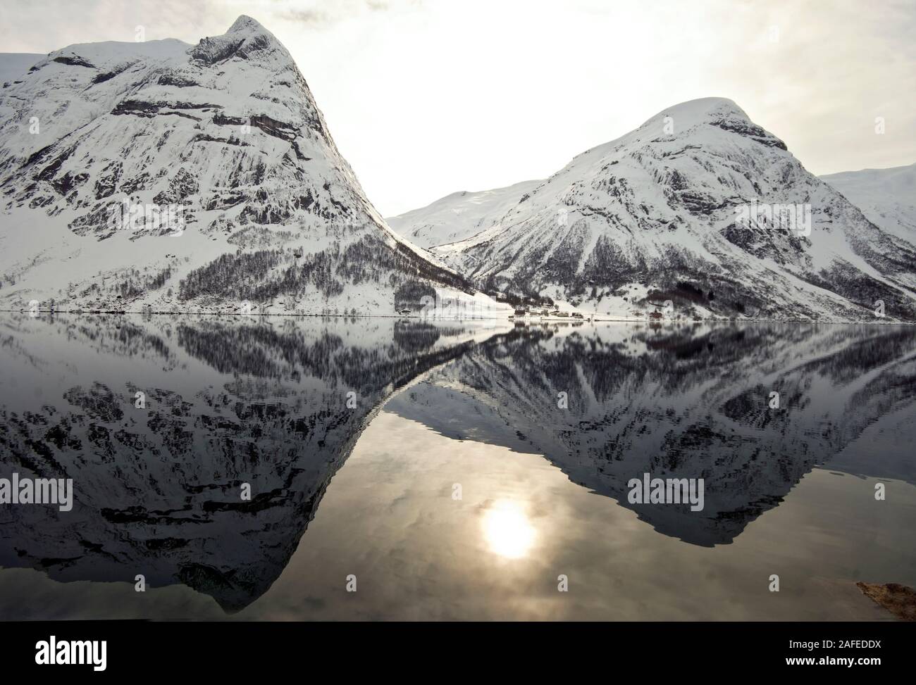 Il sole invernale e montagne innevate a Innvikfjord in Stryn, Norvegia occidentale Foto Stock