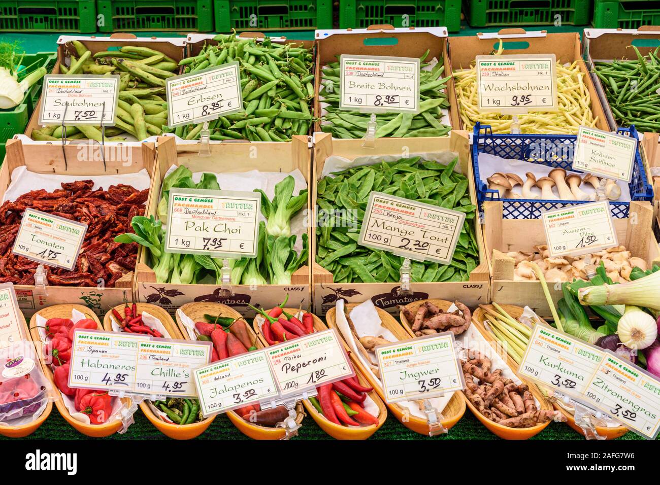 Scatole di prodotti freschi provenienti da tutto il mondo in un mercato in stallo a Monaco di Baviera, Germania Foto Stock
