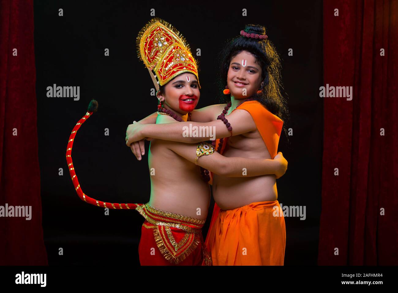 Signore abbracciando ram hanuman sul palco Foto Stock