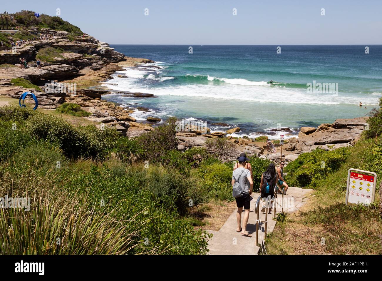 Coniugi Mackenzie Bay con persone sul Bondi a Bronte passeggiata costiera, in una giornata di sole in novembre, Sydney Australia Foto Stock