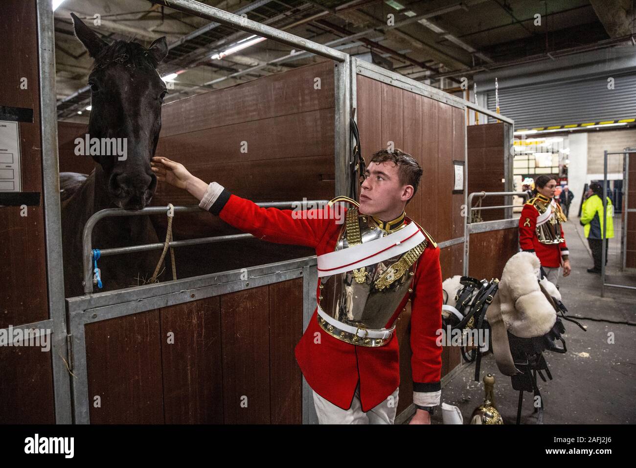 Dietro le quinte con famiglia di cavalleria reggimento montato davanti a loro le prestazioni di quest'anno a Olympia, London International Horse Show, UK. Foto Stock