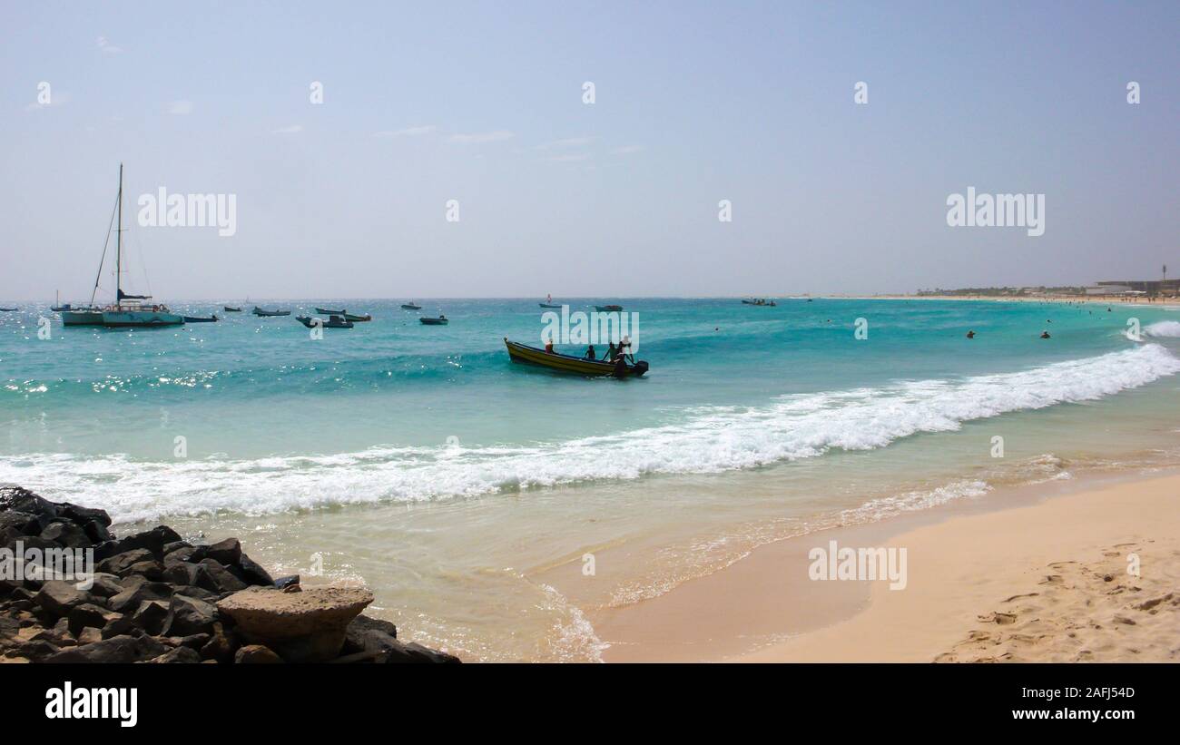 Santa Maria, Sal /Isole di Capo Verde - 19. Novembre, 2015: i pescatori africani il lancio di piccolo skiff di legno da una spiaggia tropicale sulle Isole di Capo Verde Foto Stock