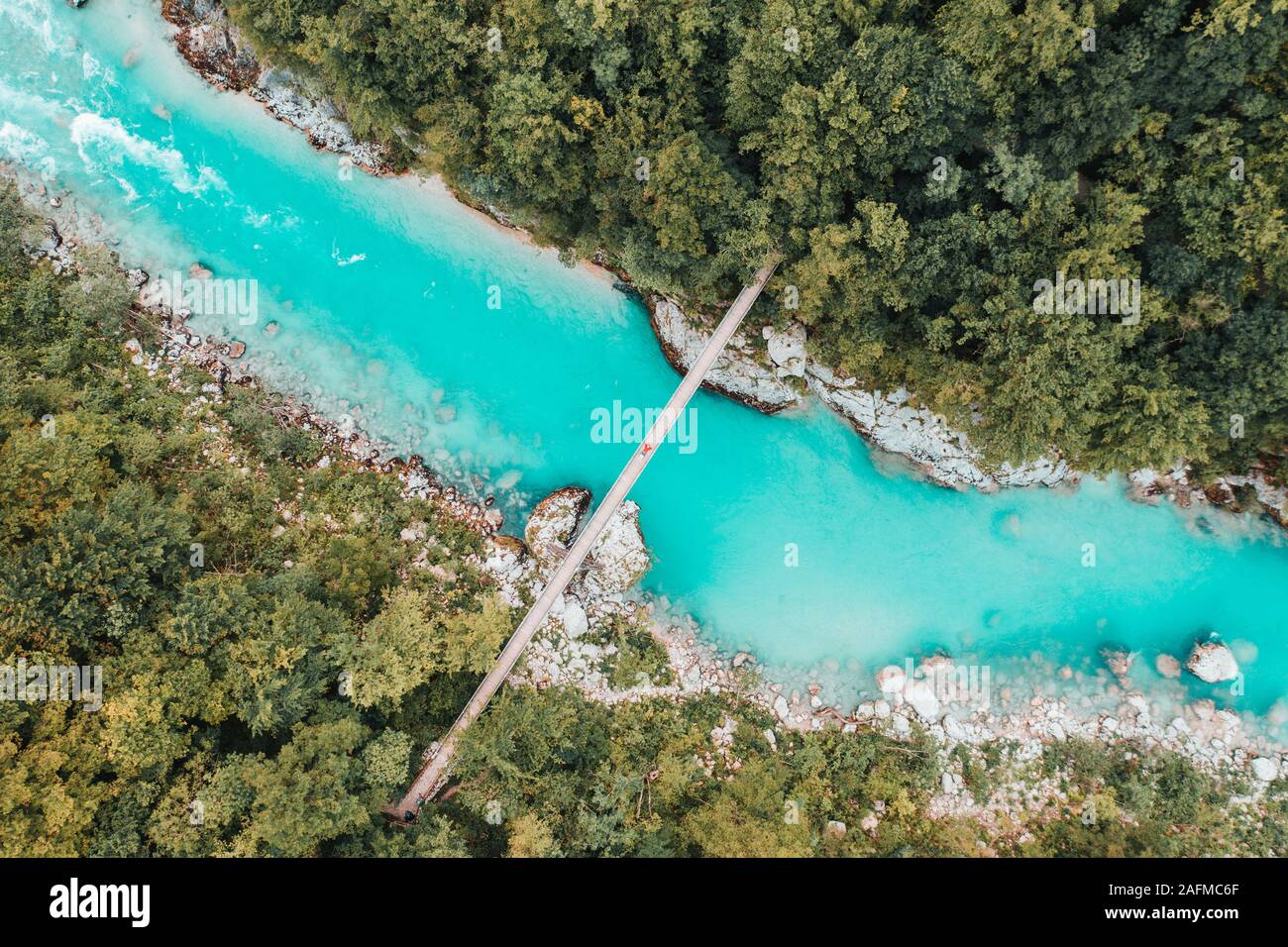 Antenna di una giovane donna recante sulla corda di sospensione ponte attraverso il fiume Foto Stock