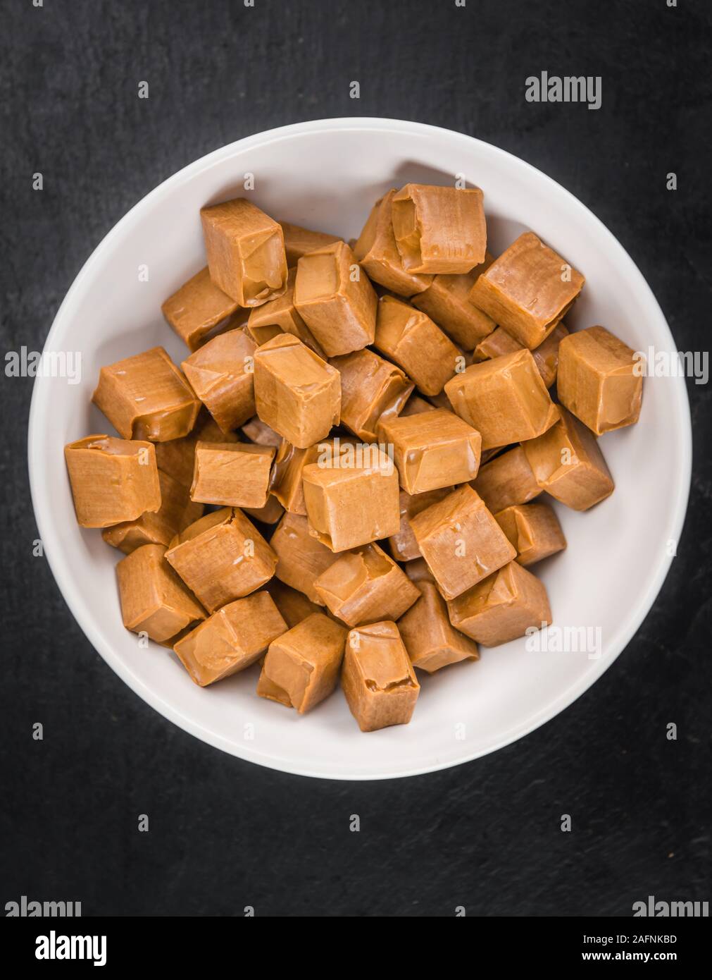 Porzione di caramella come dettagliato immagine ravvicinata su una lastra di ardesia (messa a fuoco selettiva) Foto Stock