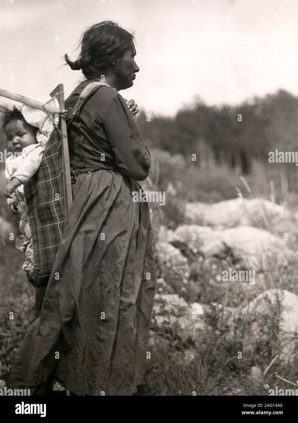 Nei primi anni del XX secolo vintage premere fotografia - Nativi Nord Americani donna indiana con bambino in Papoose, Minaki, Ontario, Canada Foto Stock