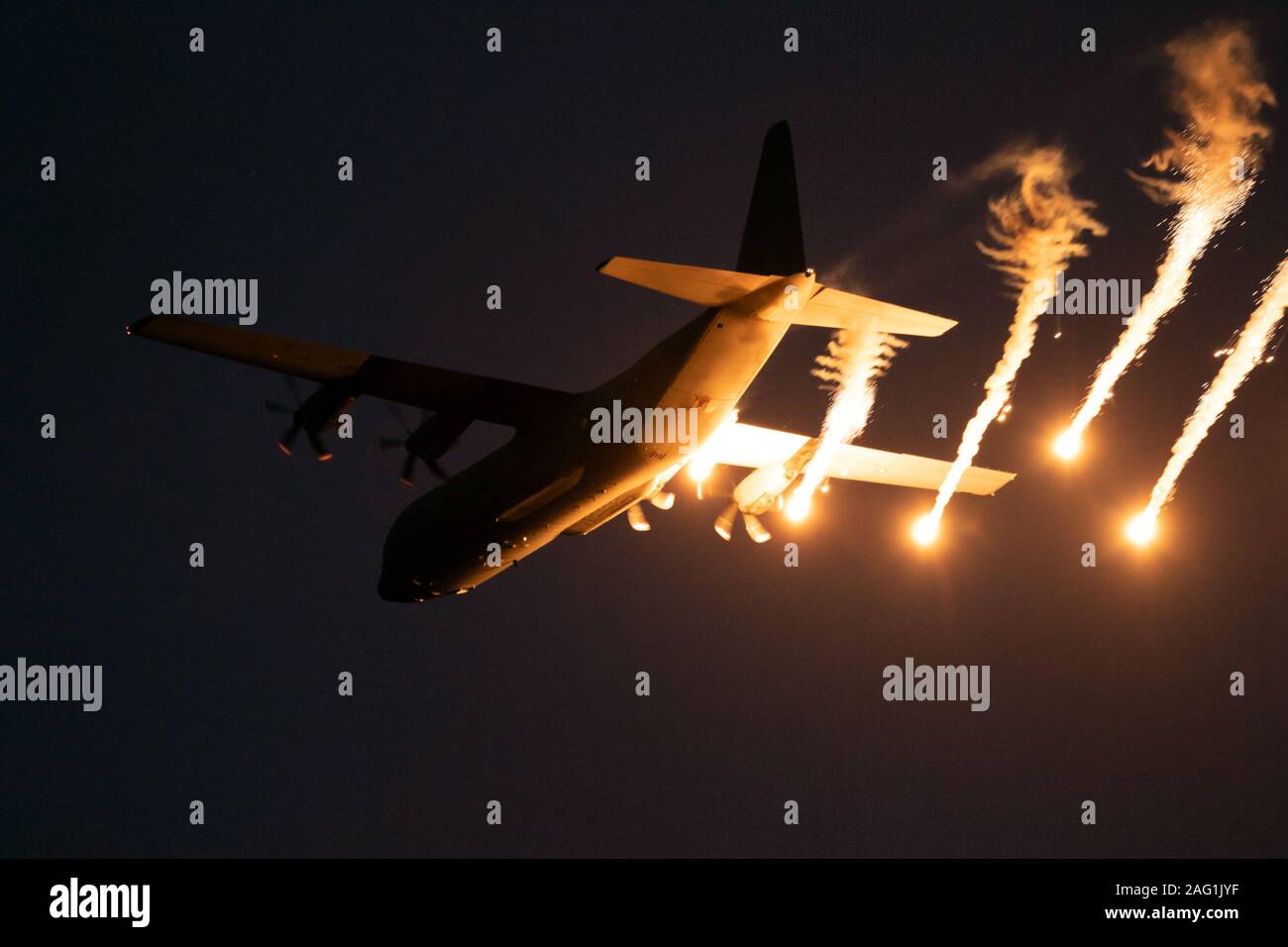 Piano militare di sparare razzi durante un volo notturno. Foto Stock