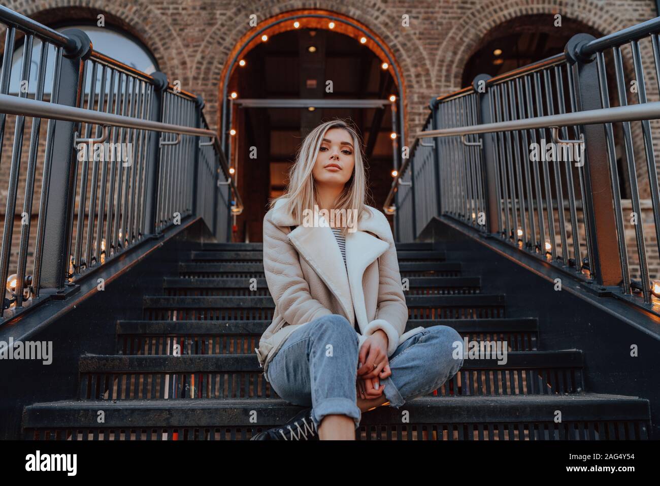 Ritratto di giovane affascinante ragazza bionda, Fashion Street Style, ponendo all'aperto Foto Stock