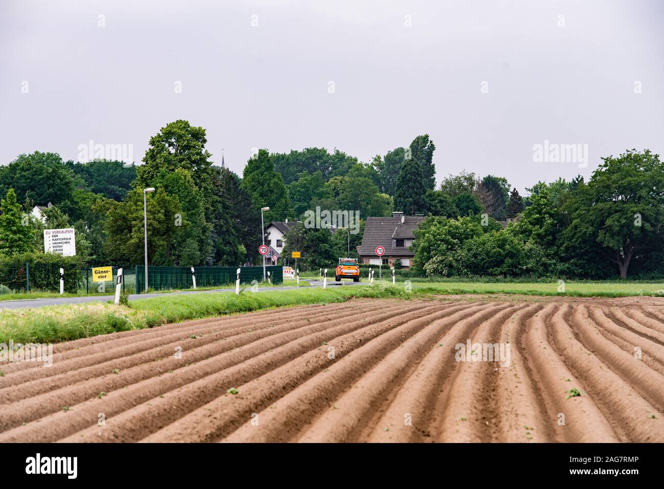 Campo Arato vicino al villaggio. Campo sullo sfondo del villaggio. Foto Stock