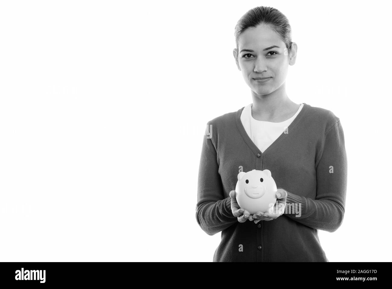 Studio shot della giovane donna bellissima azienda salvadanaio Foto Stock