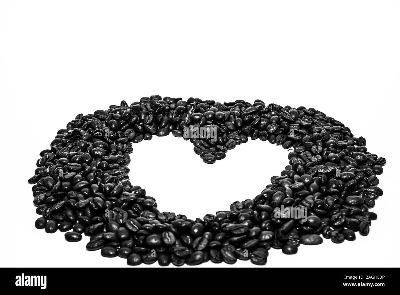 Cuore cornice formata da chicchi di caffè su uno sfondo bianco Foto Stock