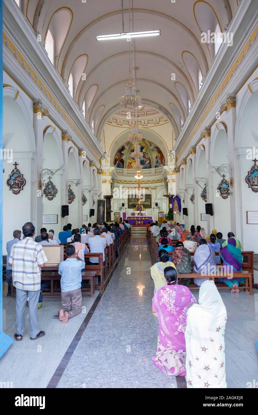 Vista posteriore di persone in preghiera all'interno di Nostra Signora della Cattedrale dell Immacolata Concezione di Puducherry, Tamil Nadu, India Foto Stock