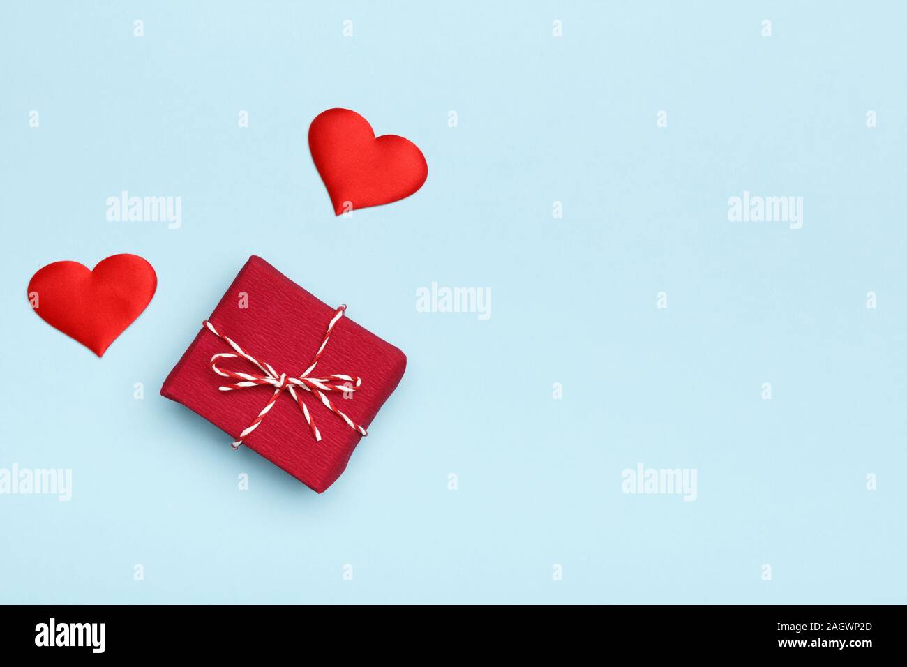 Il giorno di San Valentino cuori e confezione regalo su uno sfondo blu. Foto Stock