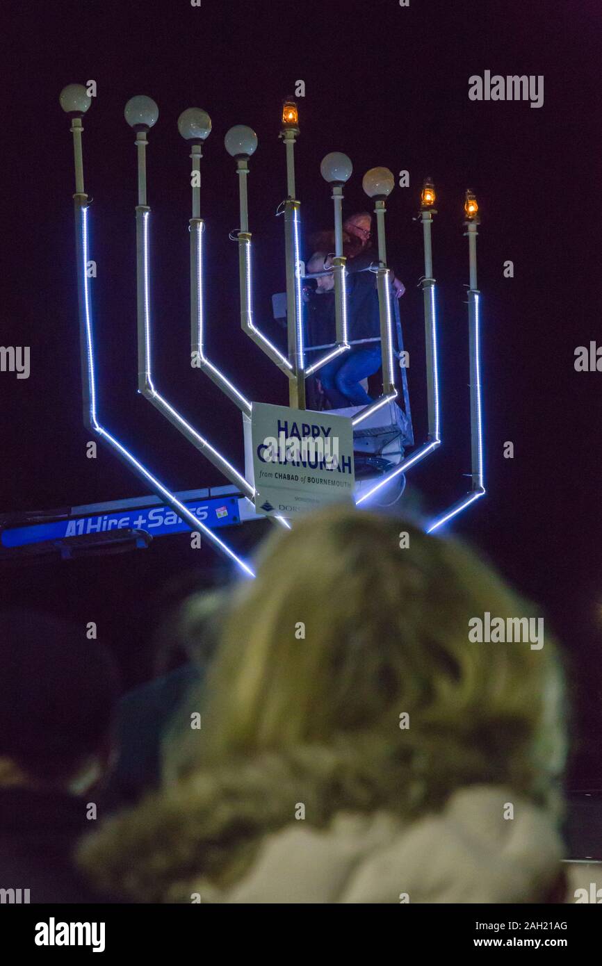 Bournemouth Dorset, Regno Unito. 23 dic 2019. Giant Menorah illuminazione a Chanukah (Hanukkah) la celebrazione in Bournemouth con la menorah acceso dal signor Jarvis Lazzaro e il Consigliere Susan Phillips, Sindaco di Bournemouth, ospite d'onore. Chanukah è il Jewish 8 giorno "festival delle luci" con una nightly menorah illuminazione, speciali preghiere e alimenti fritti. Credito: Carolyn Jenkins/Alamy Live News Foto Stock