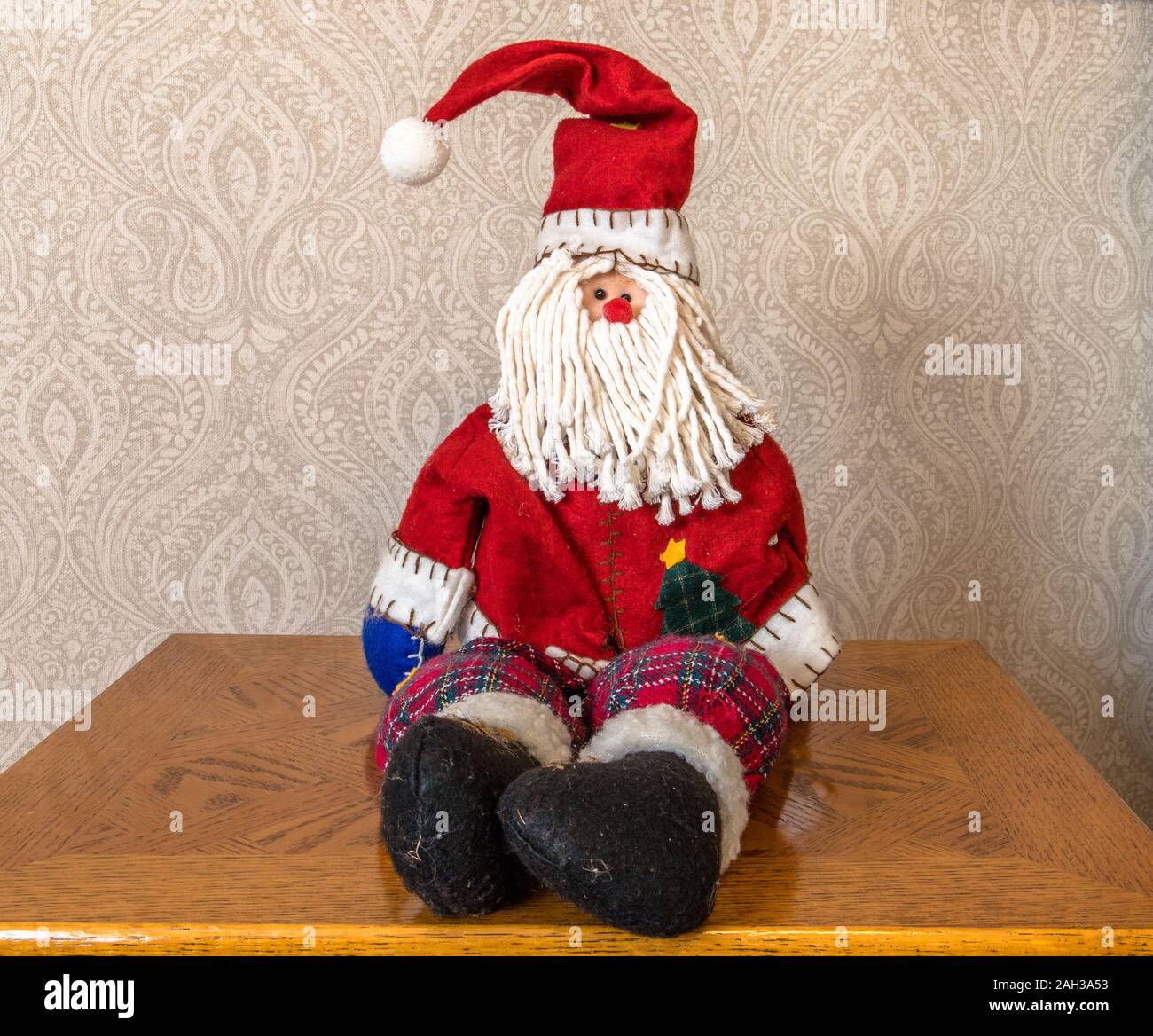 Il vecchio Babbo Natale seduto sul tavolo è in attesa per la vigilia di Natale, prese a kings lynn, norfolk, Regno Unito, il 23 Dic 2019. Foto Stock