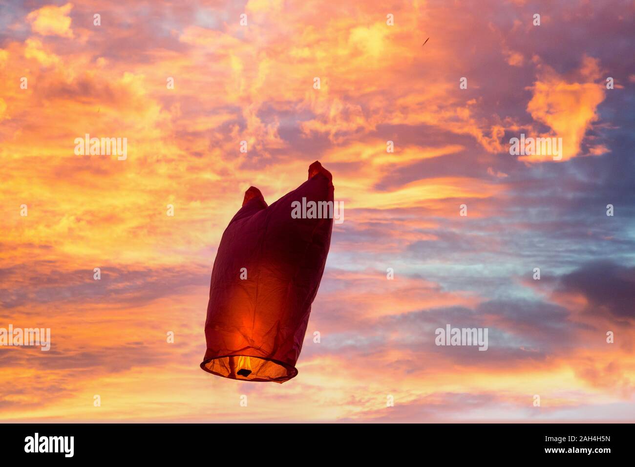 Red Sky lantern battenti contro un cielo blu Foto Stock