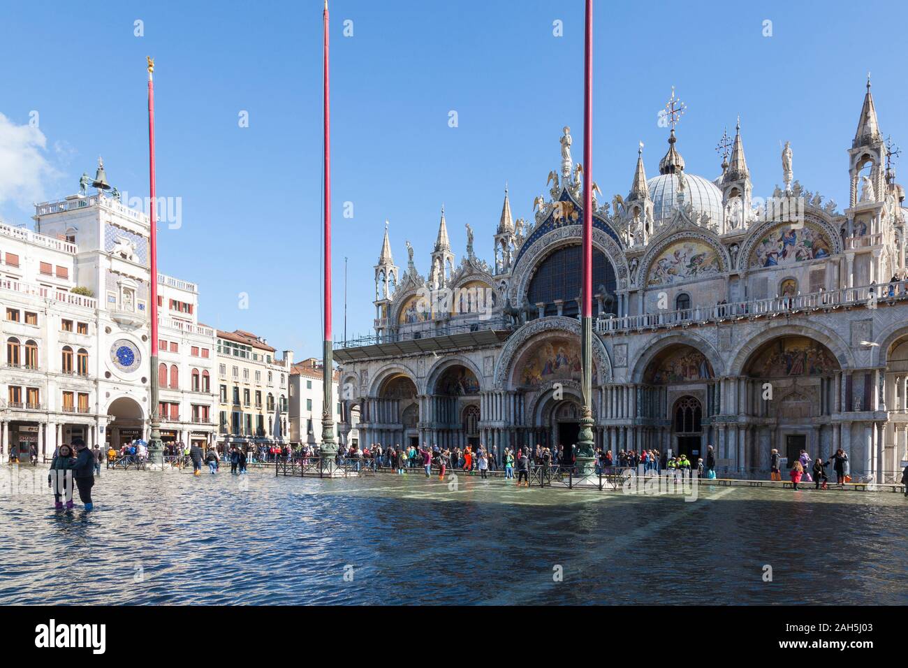 Acqua Alta inondazioni durante l estrema alta marea Piazza San Marco, Venezia, Italia con persone su passeroles o passaggi pedonali nelle vicinanze del Basilica di San Marco Foto Stock