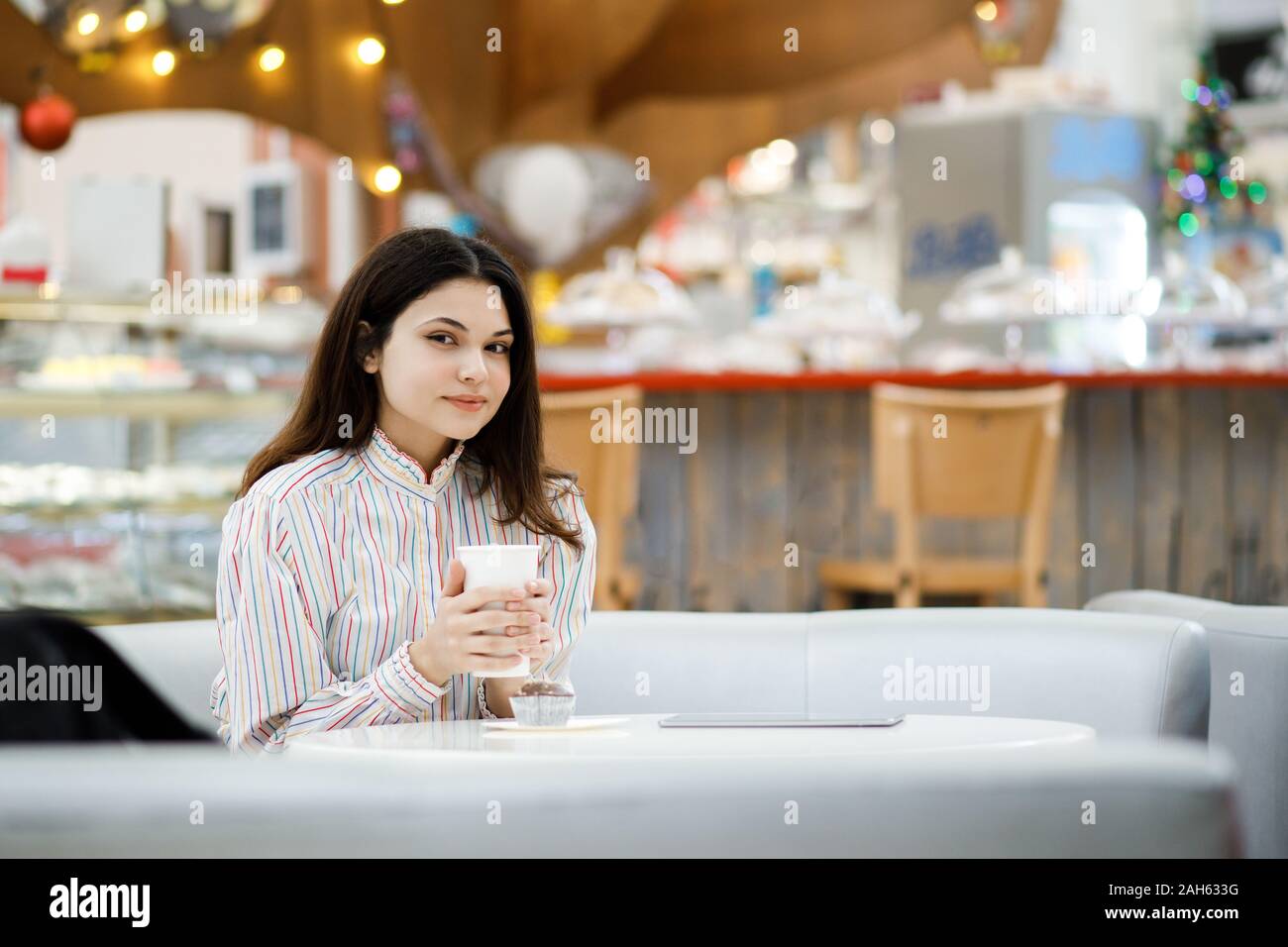 Bella donna con tavoletta digitale presso il cafe Foto Stock