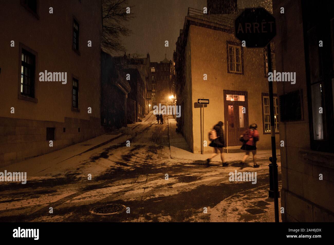 Due ragazze in esecuzione attraverso la neve di notte, Old Quebec City, in Canada Foto Stock