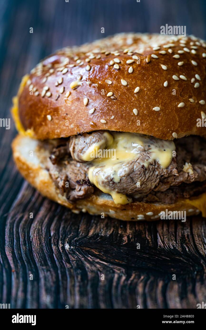 Bistecca hamburger fatto con carne di agnello Lokum e il formaggio Cheddar / Hamburger o Cheeseburger sulla superficie di legno. Fast Food. Foto Stock