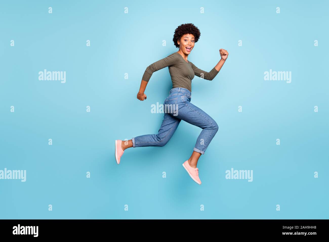 Lunghezza piena dimensione corpo foto di allegro fast quick nero donna jumping in marcia verso lo shopping mall il più rapidamente possibile indossare jeans denim Foto Stock