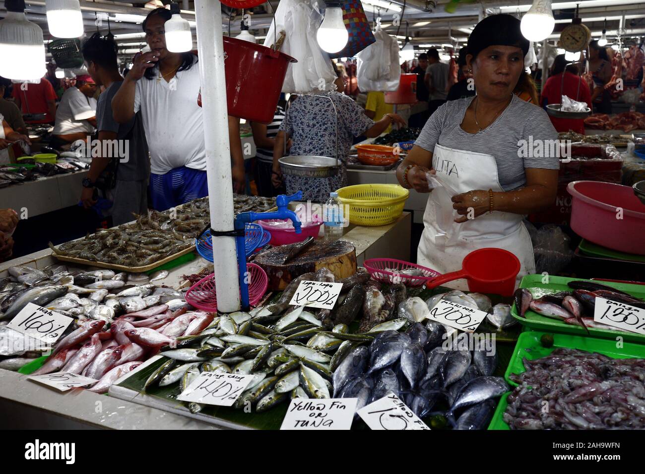 Antipolo City, Filippine - 23 dicembre 2019: fornitori ad un pubblico mercato umido vendere pesce e altri piatti di pesce per i clienti. Foto Stock